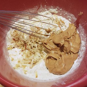 Mixing the apple & peanut butter into the flour mixture