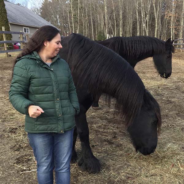 Amy with her two Friesians
