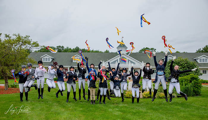 Children in show outfits showing ribbons in the air