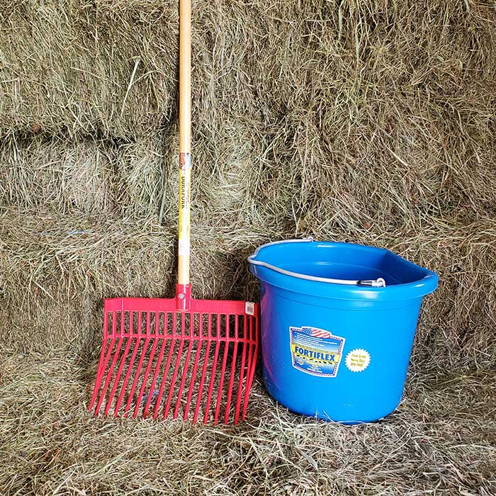 Pitchfork and flatback bucket on hay bales