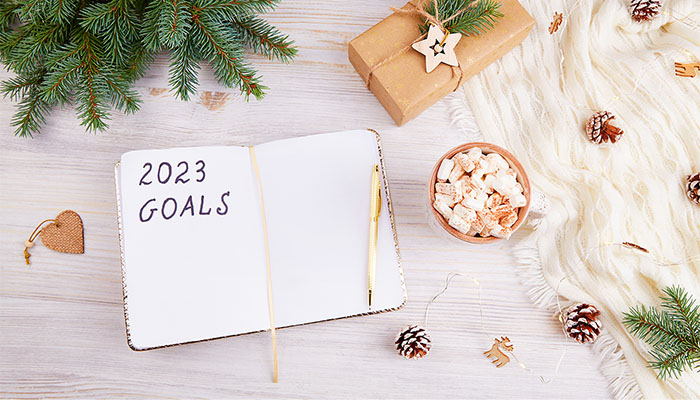 An open notebook with 2023 goals letters text