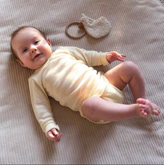 Baby wearing an Engel wool onesie