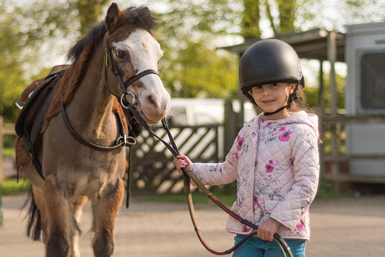 Girl leading pony